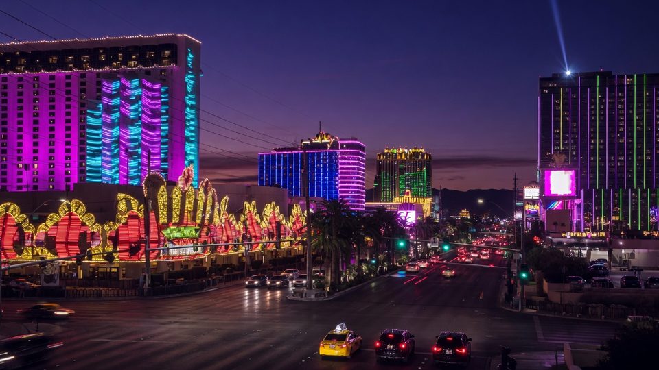 Las Vegas Boulevard at dusk, neon hotel towers and traffic on the Strip