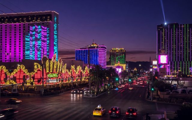 Las Vegas Boulevard at dusk, neon hotel towers and traffic on the Strip