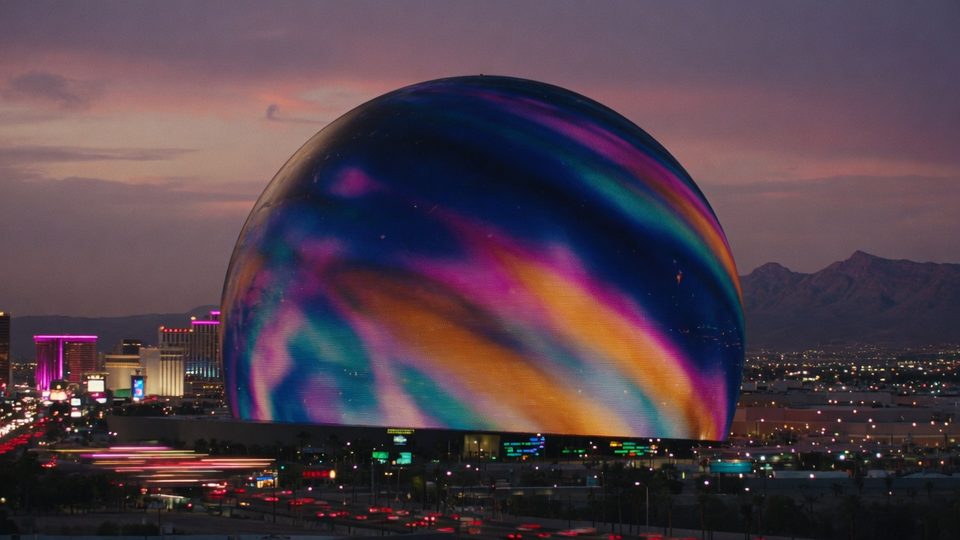 The Sphere in Las Vegas at dusk, LED skin glowing against desert mountains
