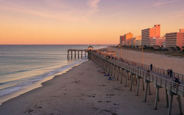 Virginia Beach oceanfront pier at sunset with the Atlantic and hotel strip